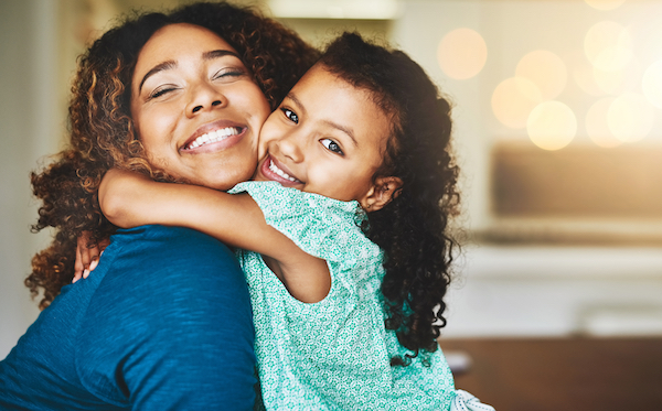 Mother smiling with young daughter